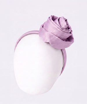 Lilac rose bow headband for girls by Mama Luma, styled as an elegant hair accessory for weddings, celebrations, and special occasions.