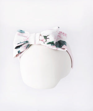 Pink floral bow headband for girls featuring soft rose print fabric, perfect for weddings, birthdays, and family portraits