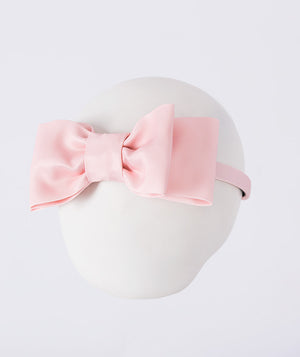 Mahe Lotus Bow Headband featuring a structured blush pink bow crafted from premium lightweight fabric, designed as an elegant hair accessory for birthdays, weddings, christenings, and special occasions.