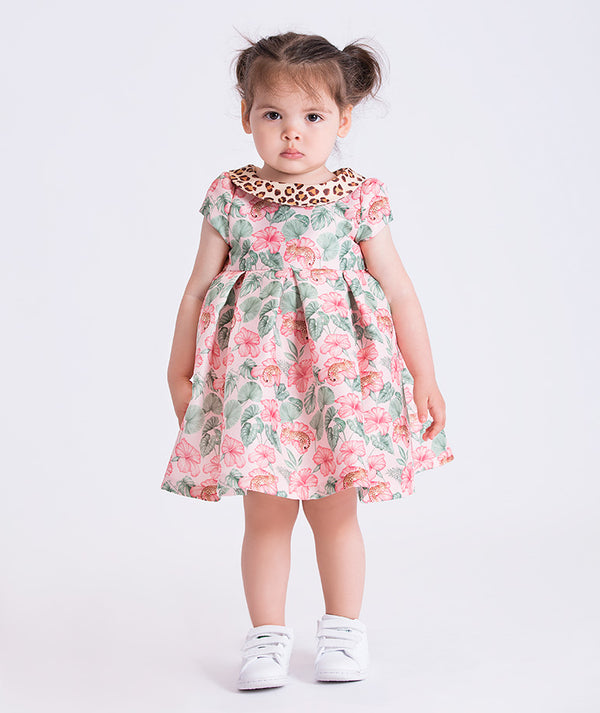 Front view of the Mahe Lotus Floral Baby Dress featuring a short-sleeve floral design with contrast animal-print collar, crafted from premium lightweight fabric with cotton lining, designed for babies ages 12–36 months for birthdays and special occasions.