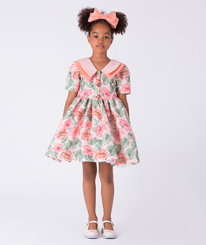 Front view of the Mahe Lotus Floral Girls Dress by Mama Luma, featuring a flared silhouette, Peter Pan collar, and lotus floral print on premium lightweight fabric, fully cotton lined for comfort, designed for girls ages 3–12 for birthdays, Easter, and special occasions.