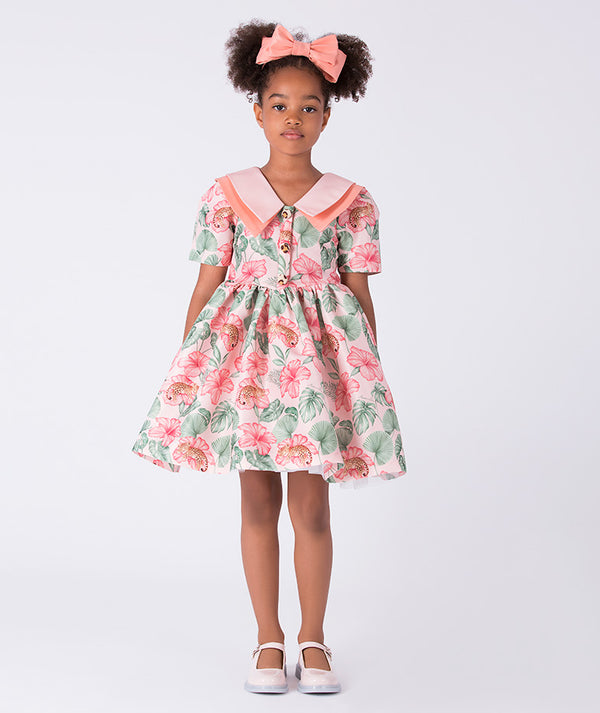 Front view of the Mahe Lotus Floral Girls Dress by Mama Luma, featuring a flared silhouette, Peter Pan collar, and lotus floral print on premium lightweight fabric, fully cotton lined for comfort, designed for girls ages 3–12 for birthdays, Easter, and special occasions.