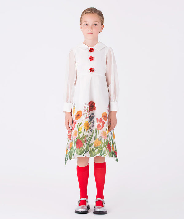 Girl wearing Mama Luma’s Asagao Flowers Dress from the Christmas Asagao Collection, featuring red rose buttons, sheer sleeves, and a floral hem — perfect for Christmas, weddings, and winter celebrations. Available in girls’ sizes 3–12Y.