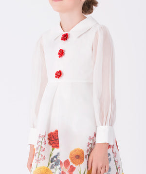Luxury ivory floral girls’ dress by Mama Luma with sheer organza sleeves and red rose buttons, designed for Christmas gatherings, birthdays, and holiday portraits. Available in sizes 3–12Y.