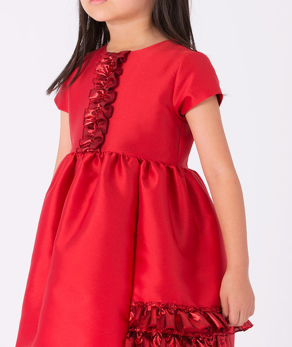 Festive red satin girls’ dress by Mama Luma featuring elegant ruffle details and short sleeves — ideal for Christmas events, pageants, and family gatherings. Available in sizes 3–12 Y.