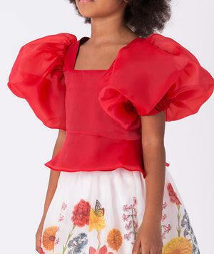 Festive two-piece set from Mama Luma’s Asagao Collection featuring a red puff-sleeve top and ivory floral skirt, ideal for Christmas parties, pageants, and family gatherings. Available in sizes 3–12 Y.