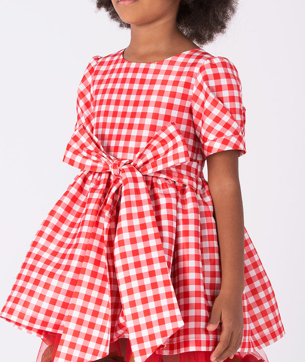 Festive plaid Christmas dress for girls by Mama Luma featuring 3D petal details and a statement bow — ideal for pageants and family celebrations. Available in sizes 3–12 Y.