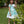 Load image into Gallery viewer, 7 years old girl in a light blue dress with floral pattern standing in a garden.
