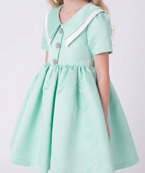 Close-up detail of the Swan Pearl Mint Girls Dress highlighting the mint satin fabric, soft pink Peter Pan collar, and premium lightweight woven fabric texture, fully cotton lined and ideal for festive events, family photos, and elegant celebrations for ages 3–12.