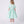 Charger l'image dans la galerie, Back view of the Swan Pearl Mint Dress showing the refined collar detail, tailored bodice, and softly flared skirt crafted from breathable lightweight fabric, designed for girls ages 3–12 for Eid celebrations, garden parties, and spring–summer occasions.
