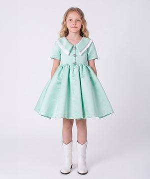 Front view of the Swan Pearl Mint Girls Dress by Mama Luma, featuring a flared silhouette, Peter Pan collar, and premium lightweight fabric, fully cotton lined for comfort, designed for girls ages 3–12 for birthdays, Easter, and special occasions.