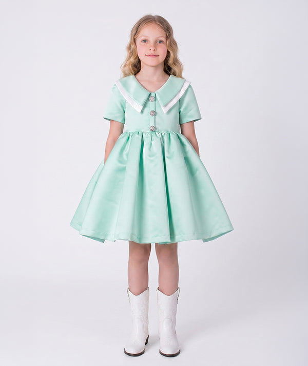 Front view of the Swan Pearl Mint Girls Dress by Mama Luma, featuring a flared silhouette, Peter Pan collar, and premium lightweight fabric, fully cotton lined for comfort, designed for girls ages 3–12 for birthdays, Easter, and special occasions.