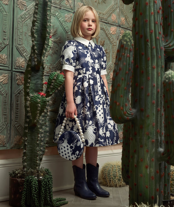 Mama Luma navy women’s dress editorial featuring elegant special occasion styling from the women’s occasionwear collection.