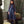 Load image into Gallery viewer, Mama Luma navy women’s special occasion dress styled in an editorial setting with a refined full-length silhouette.

