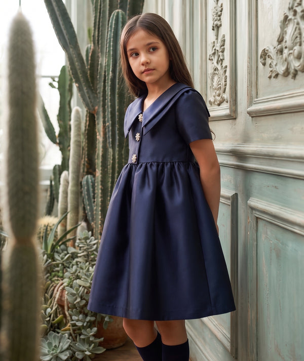 Mama Luma navy women’s occasion dress editorial showcasing an elegant silhouette for weddings, dinners and special events.