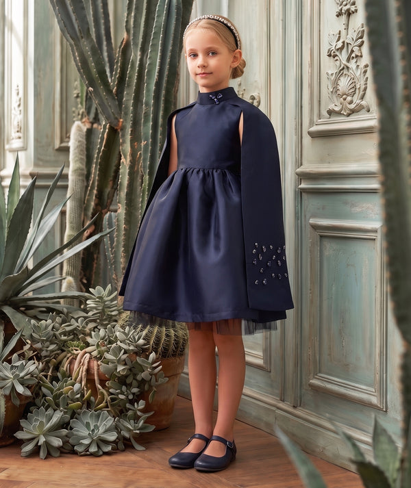 Mama Luma navy women’s dress editorial featuring sophisticated special occasionwear styling and a graceful silhouette.
