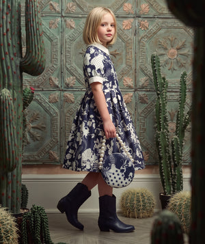 Mama Luma navy women’s special occasion dress editorial featuring polished styling for celebrations and formal events.