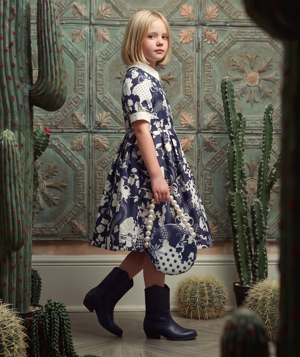 Mama Luma navy women’s special occasion dress editorial featuring polished styling for celebrations and formal events.