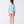 Carica l'immagine nel visualizzatore Galleria, Girl seen from the back wearing a Mama Luma pastel printed rash guard swimsuit, featuring a ruffled hem and matching swim shoes. The design includes soft blue, mint, and pink tones. Perfect for beach days, pool fun, and summer vacations. Available in girls’ sizes 3–12 years.
