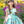 Load image into Gallery viewer, 4 years old girl in a floral dress standing in a garden with flowers and greenery.
