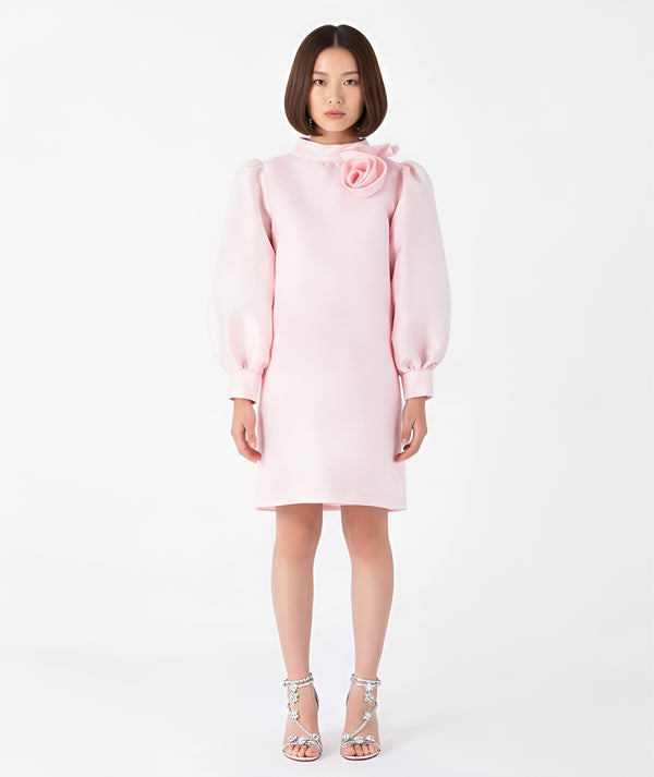 Front view of Mama Luma’s blush pink women’s dress featuring a sculptural rose neckline and voluminous long sleeves. Designed for Mommy & Me matching looks, this elegant satin piece is ideal for Christmas parties, family gatherings, and winter celebrations. Available in sizes XS–XL.
