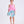 Load image into Gallery viewer, Girl wearing Mama Luma Kohana Feathers two-piece outfit with pink feather top and floral skirt, front view.
