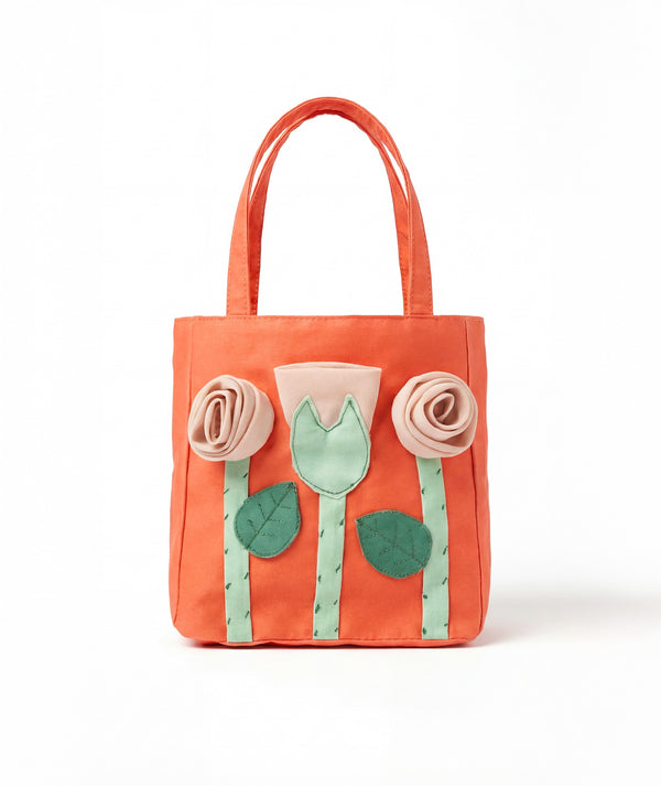 Orange girls tote bag with 3D flower appliqués from Mama Luma’s Marambaia Collection.