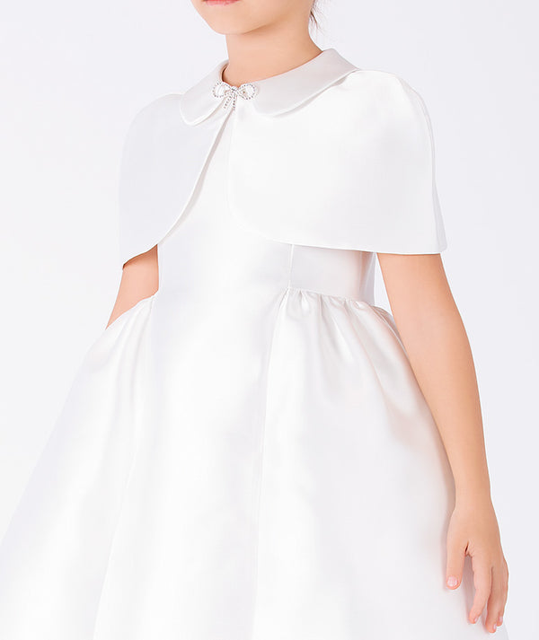 Close-up of Mikado Satin Girls Cape Dress in ivory mikado satin for girls ages 3 to 12, highlighting fabric texture and designer details