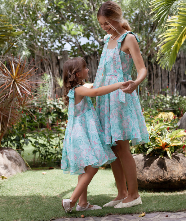 Mother and daughter walking in matching mint floral dresses