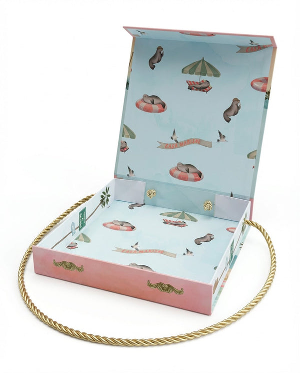 Mother holding a Casa Marisol luxury newborn gift box, alternate 3