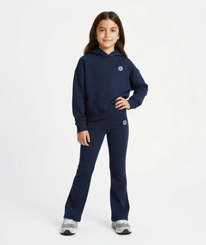 Girl wearing a navy hoodie and matching pants, styled for everyday athleisure, school days, and active play, available in sizes 3–14