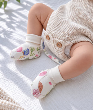 Ocean-print baby booties, comfortable newborn footwear.