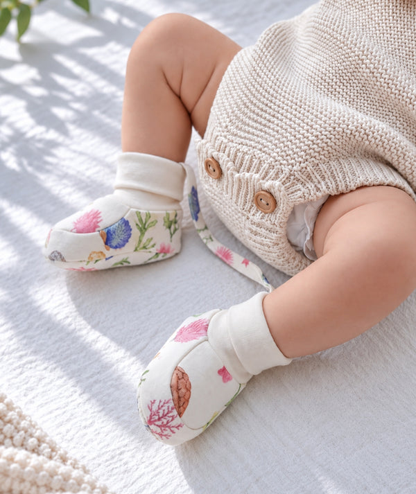 Ocean-print baby booties, comfortable newborn footwear.