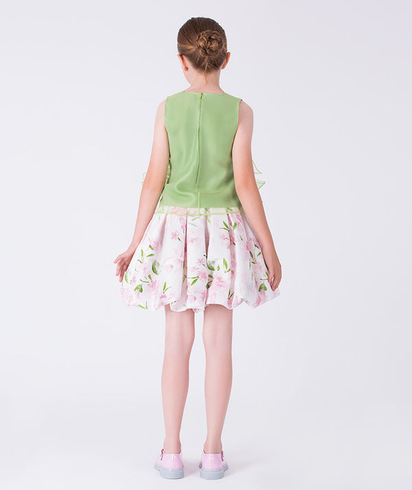 Back view of a two-piece girls outfit with a structured top and flared floral skirt, finished with a clean and elegant silhouette.