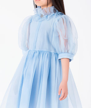 Model wearing Organza Ruffles Girls Dress in powder blue organza for girls ages 3 to 12, from Mama Luma’s premium children’s occasionwear