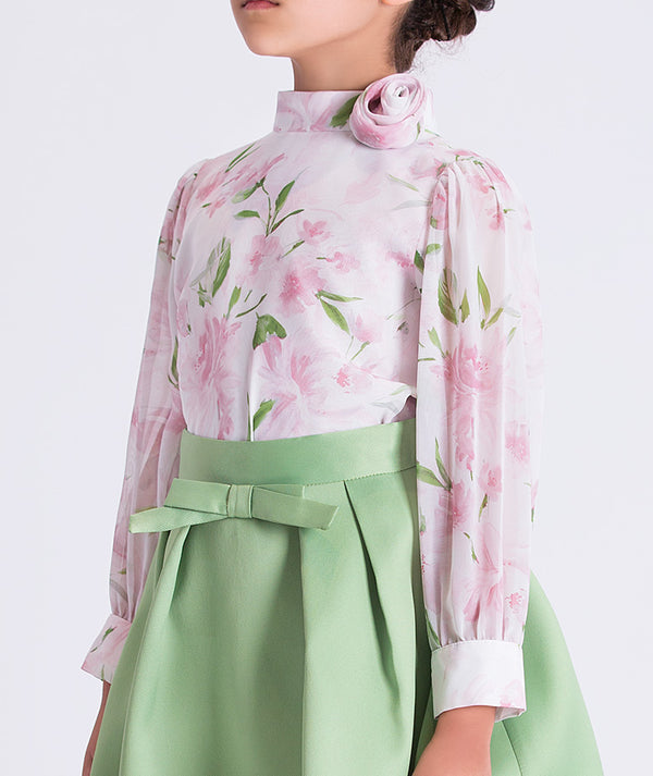 Close-up of the floral blouse and waist detail on a girls two-piece outfit, highlighting soft chiffon texture and refined tailoring for garden celebrations.