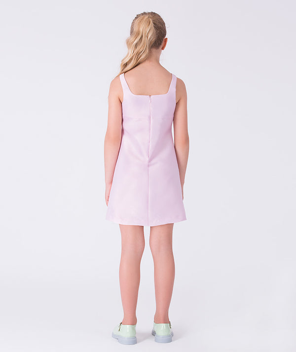 Back view of a pink girls dress with clean silhouette and minimal detailing, ideal for special occasions and formal gatherings.