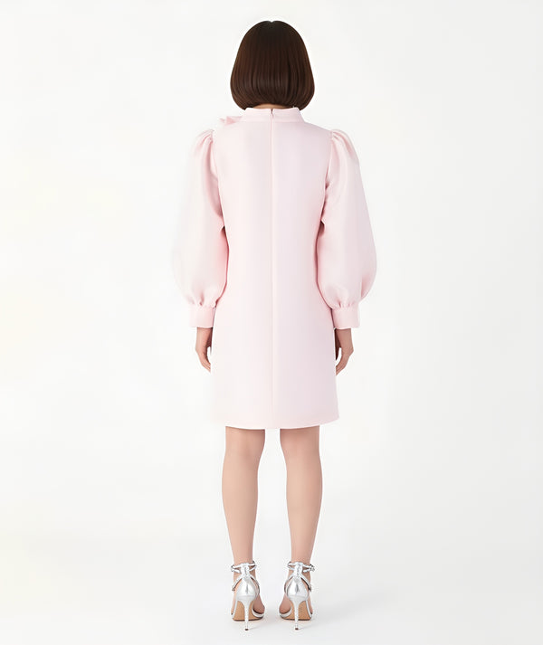 Back view of Mama Luma’s pastel pink women’s dress featuring voluminous puff sleeves and a minimal A-line silhouette, designed for elegant Mommy & Me coordination. Perfect for Christmas gatherings, family photos, and festive dinners. Available in sizes XS–XL.