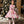 Load image into Gallery viewer, Girl wearing a pink floral chiffon dress with ribbon details beside a Christmas tree for holiday celebrations
