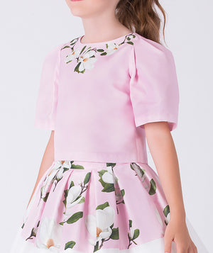 Close-up detail of a pink floral girls occasion outfit highlighting the short sleeve structured top and matching flared skirt, designed for birthdays, weddings, and special celebrations, available in sizes 3–12