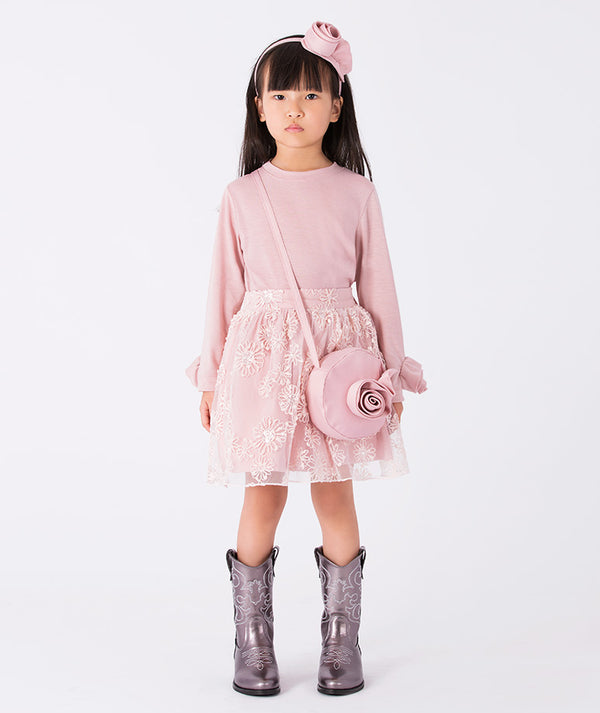 Front view of the Pink Rosette girls blouse (3–12Y), styled as an elegant outfit for special occasions, featuring long sleeves and floral cuff details.