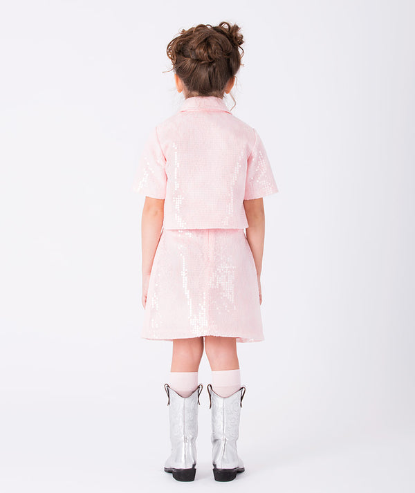 Back view of pink sequin girls’ skirt (3–12Y) featuring a short-sleeve top and A-line skirt, perfect for weddings, birthdays, and festive celebrations