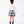 Load image into Gallery viewer, Back view of Pleated Plaid Girls Outfit with cascading ivory sleeve ruffles and powder-blue plaid shorts for girls ages 3 to 12 by Mama Luma.
