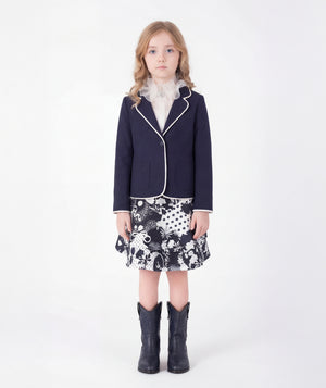 Editorial view of Ponte-Knit Piped Girls Blazer in ivory ponte knit for girls ages 3 to 12, styled for weddings, birthdays and special occasions