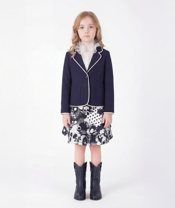 Editorial view of Ponte-Knit Piped Girls Blazer in ivory ponte knit for girls ages 3 to 12, styled for weddings, birthdays and special occasions