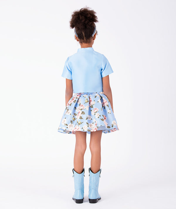 Porcelain Garden two-piece girls outfit with cropped blue jacket and floral pleated skirt back view