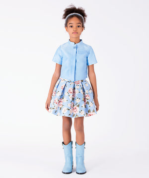 Porcelain Garden girls two-piece outfit with powder blue cropped jacket and rose print pleated skirt front view