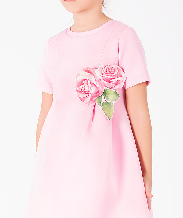 Back view of Rose Appliqué Girls Dress in blush pink structured fabric for girls ages 3 to 12, highlighting overall silhouette and styling