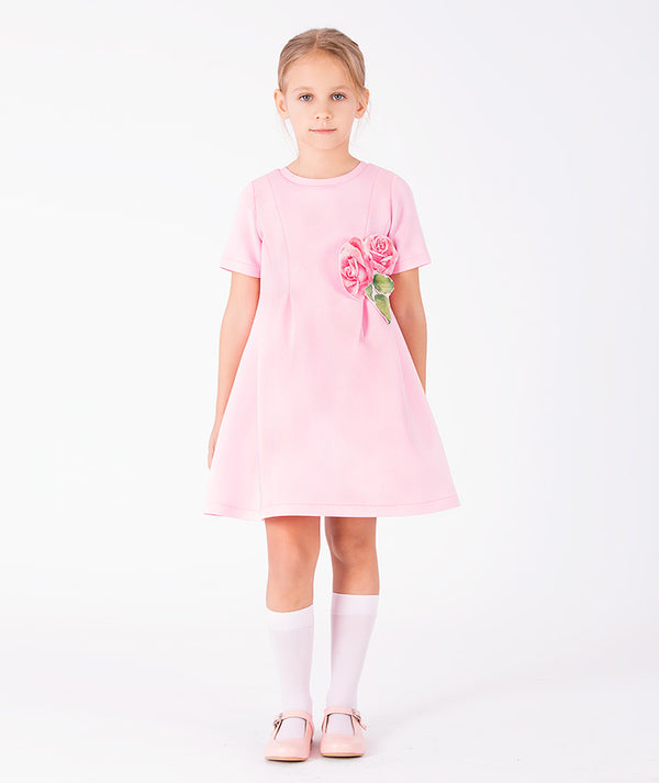 Front view of Rose Appliqué Girls Dress in blush pink structured fabric for girls ages 3 to 12, showing overall silhouette and styling