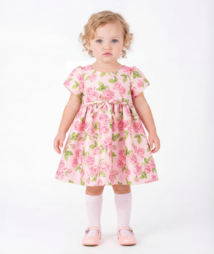 Front view of Rose Bloom Baby Dress in blush pink satin for babies 12 to 36 months, showing overall silhouette and styling